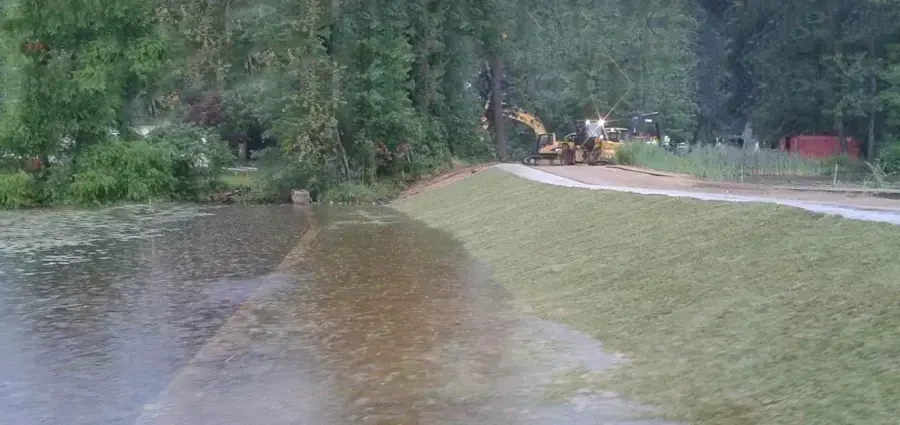 Storm water covering a lawn and low ground after heavy rain near Monroe Township